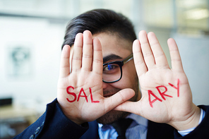 Young employee showing his palms with word salary