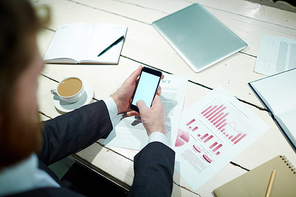 Businessman with smartphone planning work