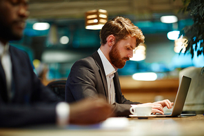 Serious young economist entering important data