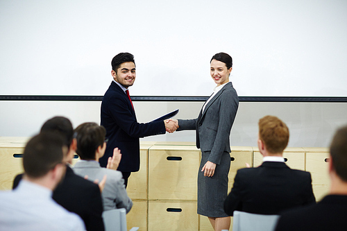 Professionals and experts congratulating graduate of business school