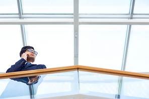 Serious entrepreneur talking to partner on cellphone