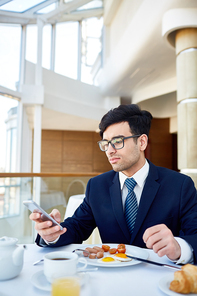 Busy leader texting in smartphone at lunch break