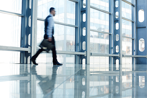 Blurred figure of businessmen walking to work