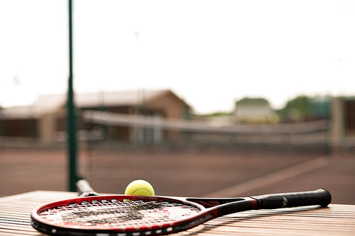 Two tennis rackets and ball on background of court or stadium or playground