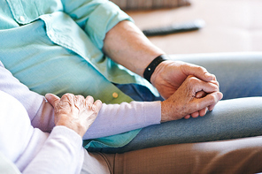 Senior man and woman in casualwear holding by hands while spending time together at leisre or weekend