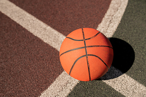 Overview of basketball gear on crossing of two white lines on stadium or field for play