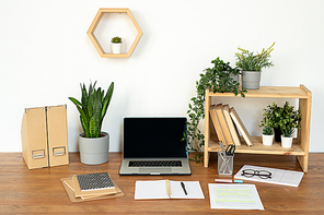 Composition of objects for work of manager, designer or student on desk by wall of office or domestic room