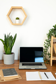 Group of objects for work of office manager, college student or creative designer on desk by wall