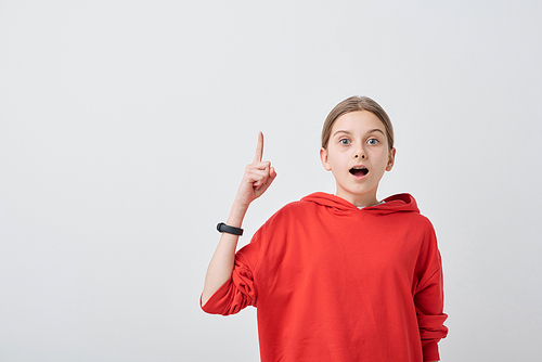 Portrait of clever teenage girl in red sweater raising index finger up while having idea