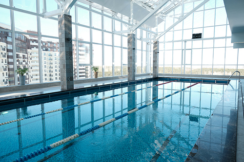 Modern swimming pool with clean water and lane divider in health club, sport and spa concept