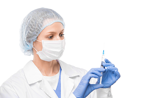 Young female in protective mask, gloves and whitecoat holding syringe with vaccine against new dangerous coronavirus before making injection