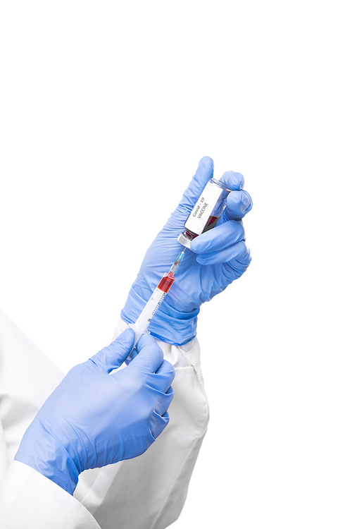 Hands of gloved virologist taking liquid anti covid19 vaccine from small bottle into syringe to make injection to sick patient