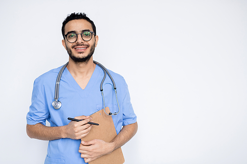 Smiling male clinician with stethoscope holding document with medical prescriprions with copyspace on the right