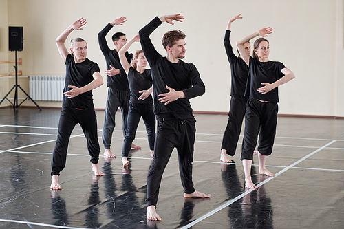 Group of male and female dancers learning new dance in rehearsal studio, horizontal shot