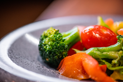 Close-up of summer salad with broccoli and tomatoes on beautiful plate