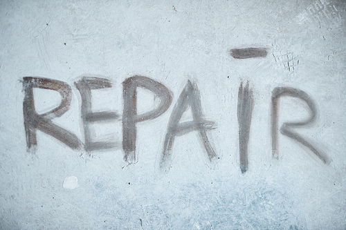 Background image of REPAIR word on concrete wall in house under construction, copy space