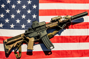 High angle view of modern army weapon on American flag, soldier equipment