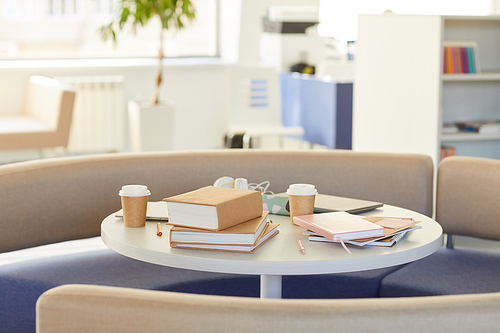 Background image of round table in library with studying supplies decorated with craft paper, copy space