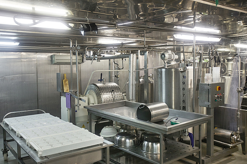 Background image or steel machine units at cheese and dairy factory, food production, copy space