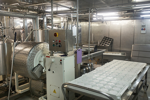 Background image or steel machinery equipment at cheese and dairy factory, food production, copy space