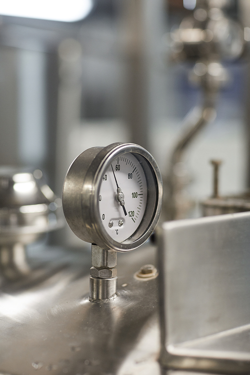 Close up background image of pressure gauge meter on steel machine unit at factory, copy space