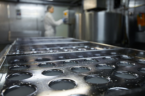 Background image of industrial conveyor belt at clean food production factory with unrecognizable female worker, copy space