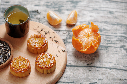 Sweet decorated mooncakes, tea and fruits served for mid autumn festival celebration