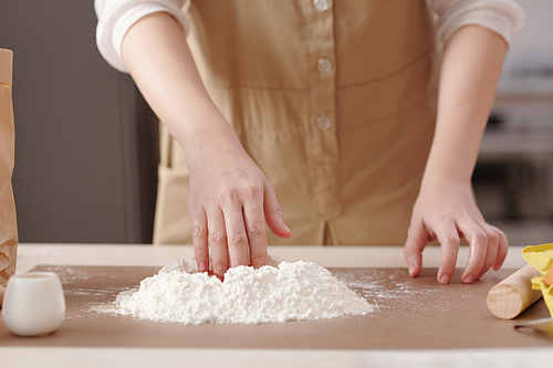 Close-up image of person mixing mooncake dough ingredients when cooking at home for mid autumn festival