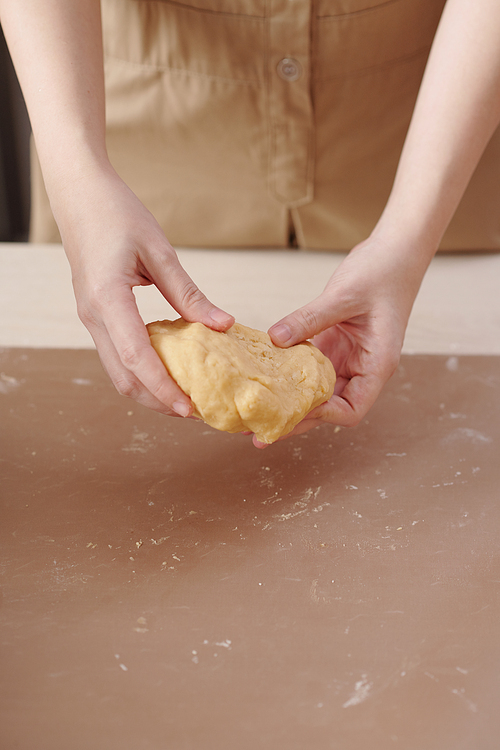Close-up image of woman kneading dough of traditional Chinese pastry for mid autumn festival