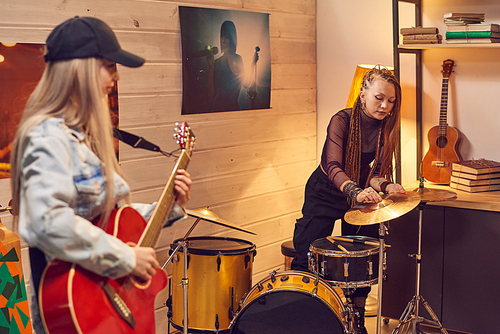 Girls with musical instruments preparing for music recording in studio