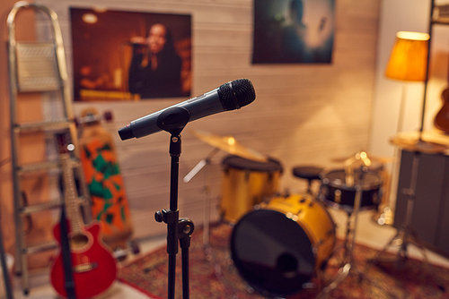 Microphone among musical instruments in sound recording studio