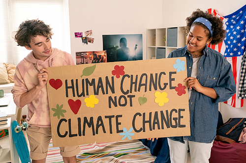 Creative intercultural teens holding climate project paper made up by themselves