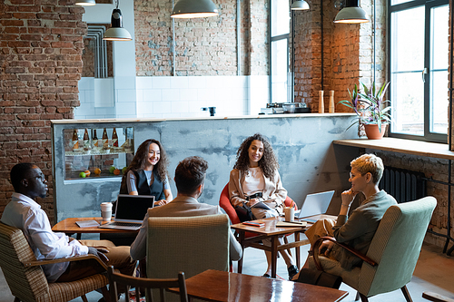 Multiracial managers having discussion of ideas at start-up meeting