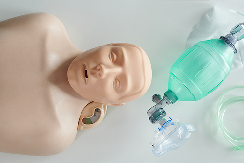 High angle view of training dummy and oxygen mask used by paramedic trainees