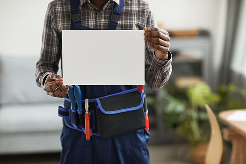 Cropped shot of unrecognizable African-American worker holding blank white sign towards camera, copy space