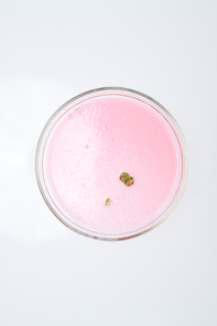 Above view of petri dish containing piece of mold grown in pink substance in chemical laboratory for new experiment