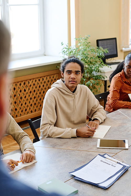 Young Black student attending language classes for immigrants struggling to answer teachers question