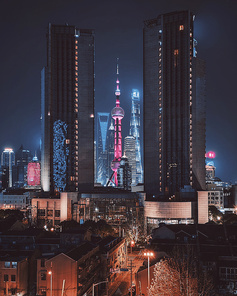 A cell phone,Travel,The city,building,At night,skyscraper,No one,hotel,high building,cityscape,Business,Downtown,skyline,twilight,finance,Lighted,The sky,The office.