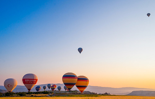 At sunrise, the balloons slowly rise, overlooking the lunar version of the cappadocia.