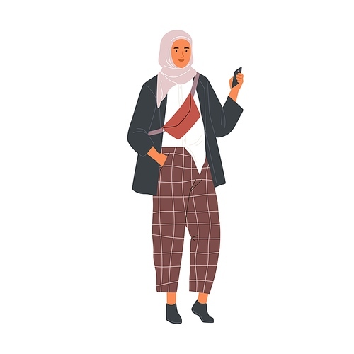 Modern Muslim woman wearing trendy casual clothes and hijab using phone. Fashion Arab female character in trousers and traditional headdress. Flat vector illustration isolated on white .