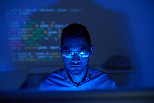 Indian software tester checking the code on computer screen