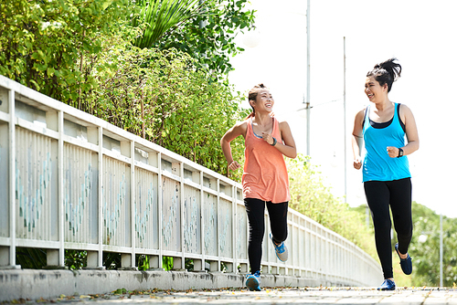 Pretty Vietnamese girls having fun when jogging in the morning