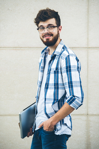 Portrait of cheerful developer with laptop 