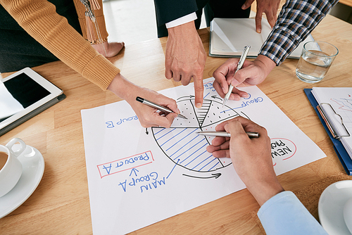 Hands of business people pointing at circle diagram