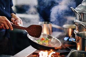 Chef frying vegetables for the restaurant dish