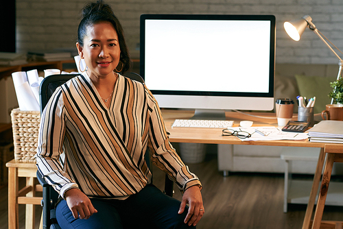Portrait of pretty Indonesian female entrepreneur in her office