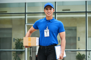 Portrait of smiling courier with a package