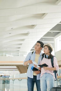 Young Asian couple waiting for departure in airport