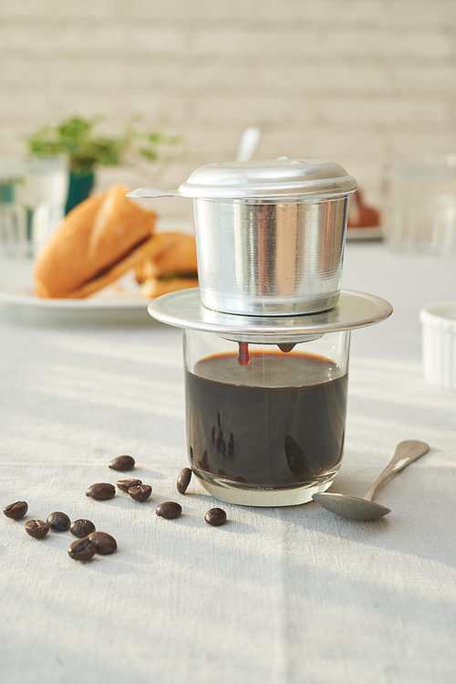 Phin - Vietnamese coffee maker and beans on table