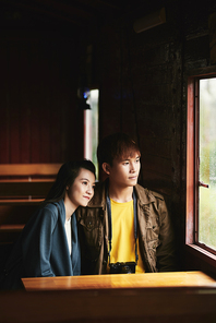 Vietnamese young couple traveling by train between the cities